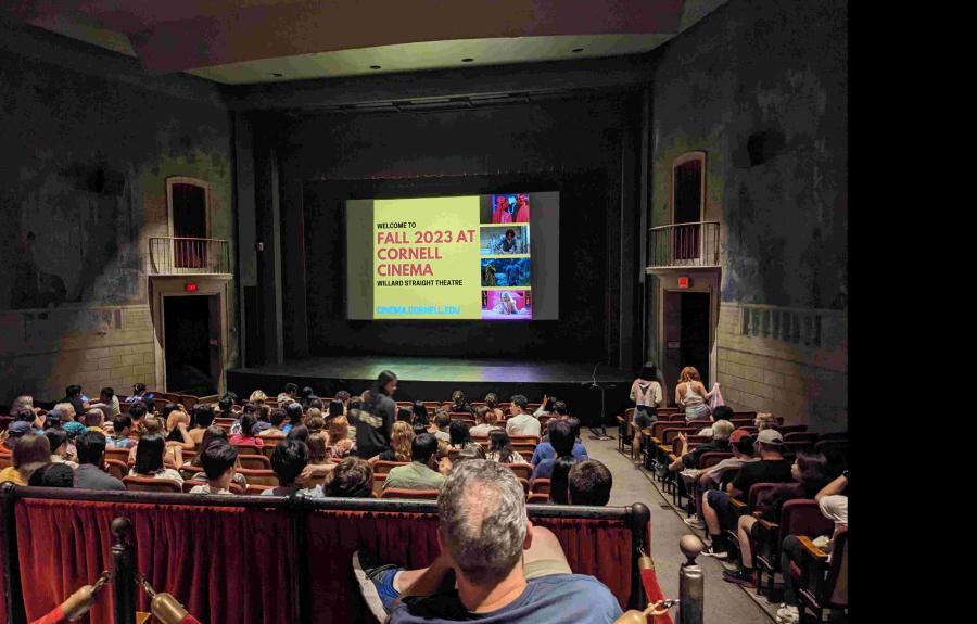 Theater space with yellow slide that reads Fall 2023 at Cornell Cinema