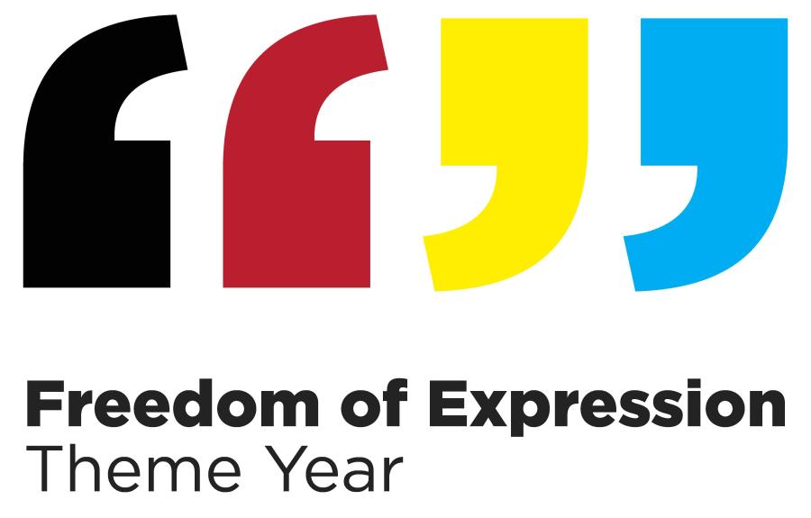 Red, black, yellow, and blue quotation marks above the words "Freedom of Expression Theme Year"