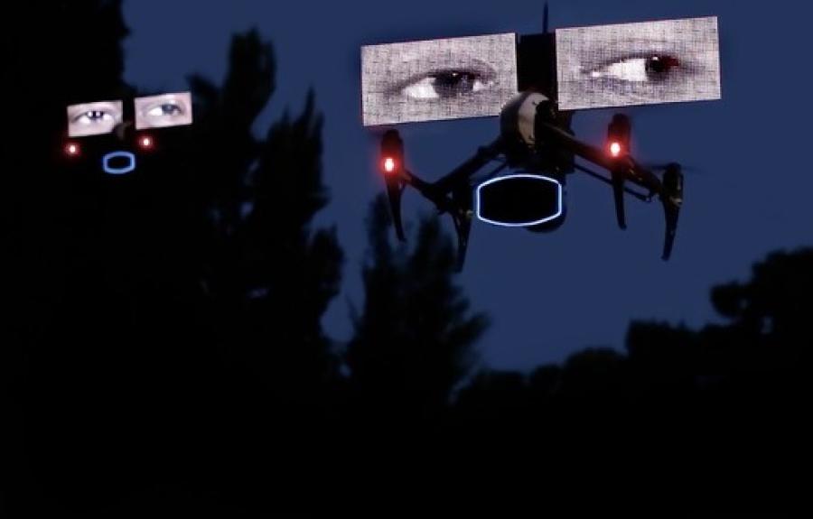 A drone carrying digital images of two human eyes flying at dusk.