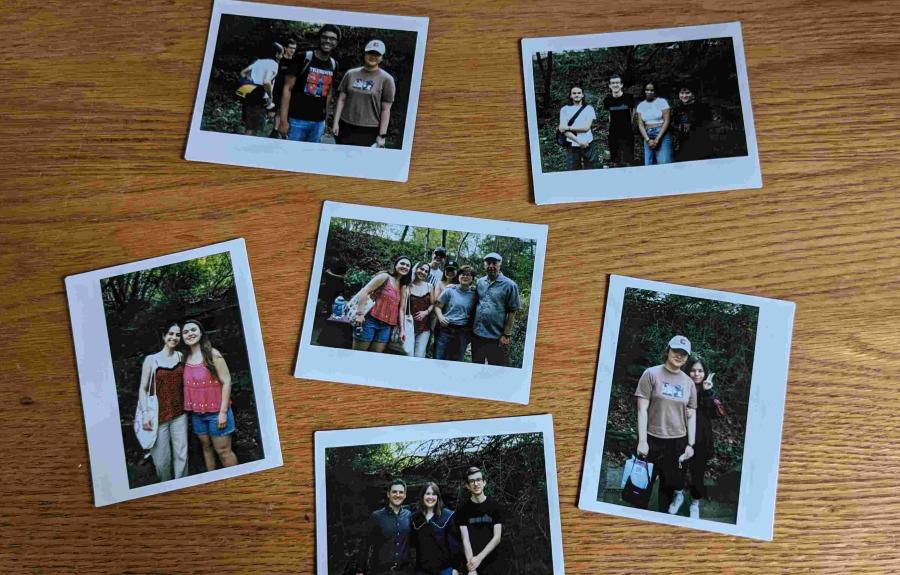 A selection of six Polaroid photos laid on a brown wooden table.