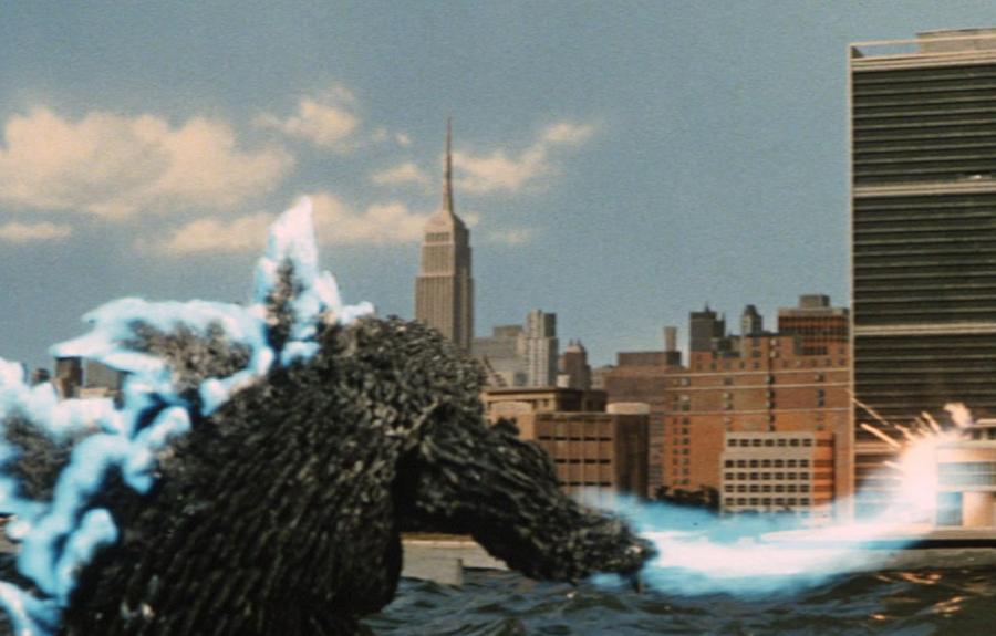 A reptilian monster with an electrified spine attacking a city.