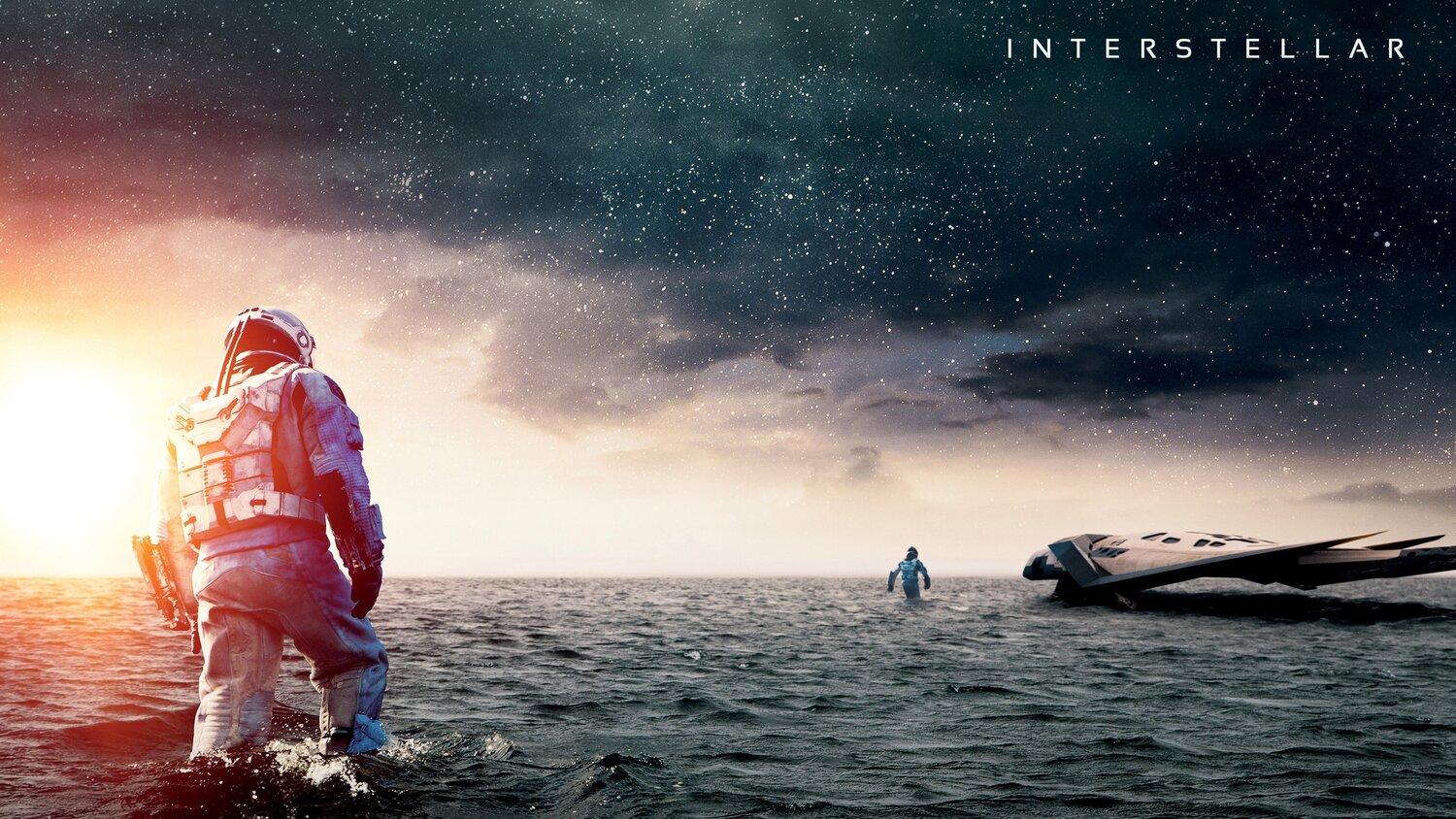 An astronaut standing knee-deep in water looking at a space ship.
