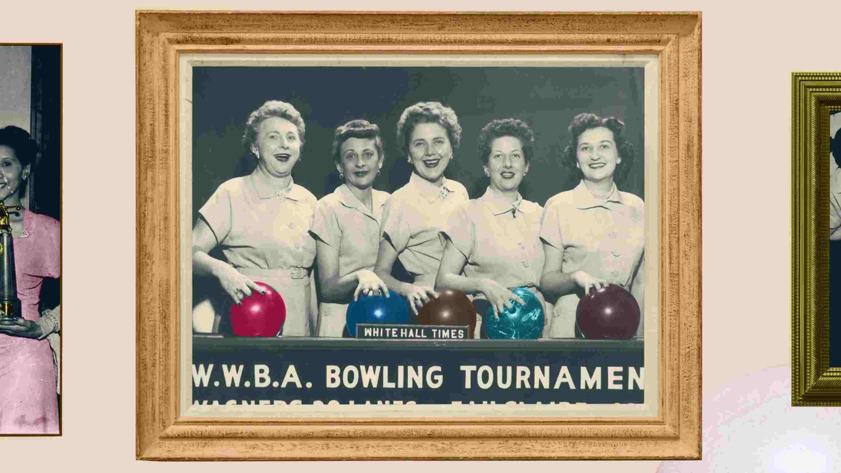 Black and white photo of five women holding bowling balls that are in color.