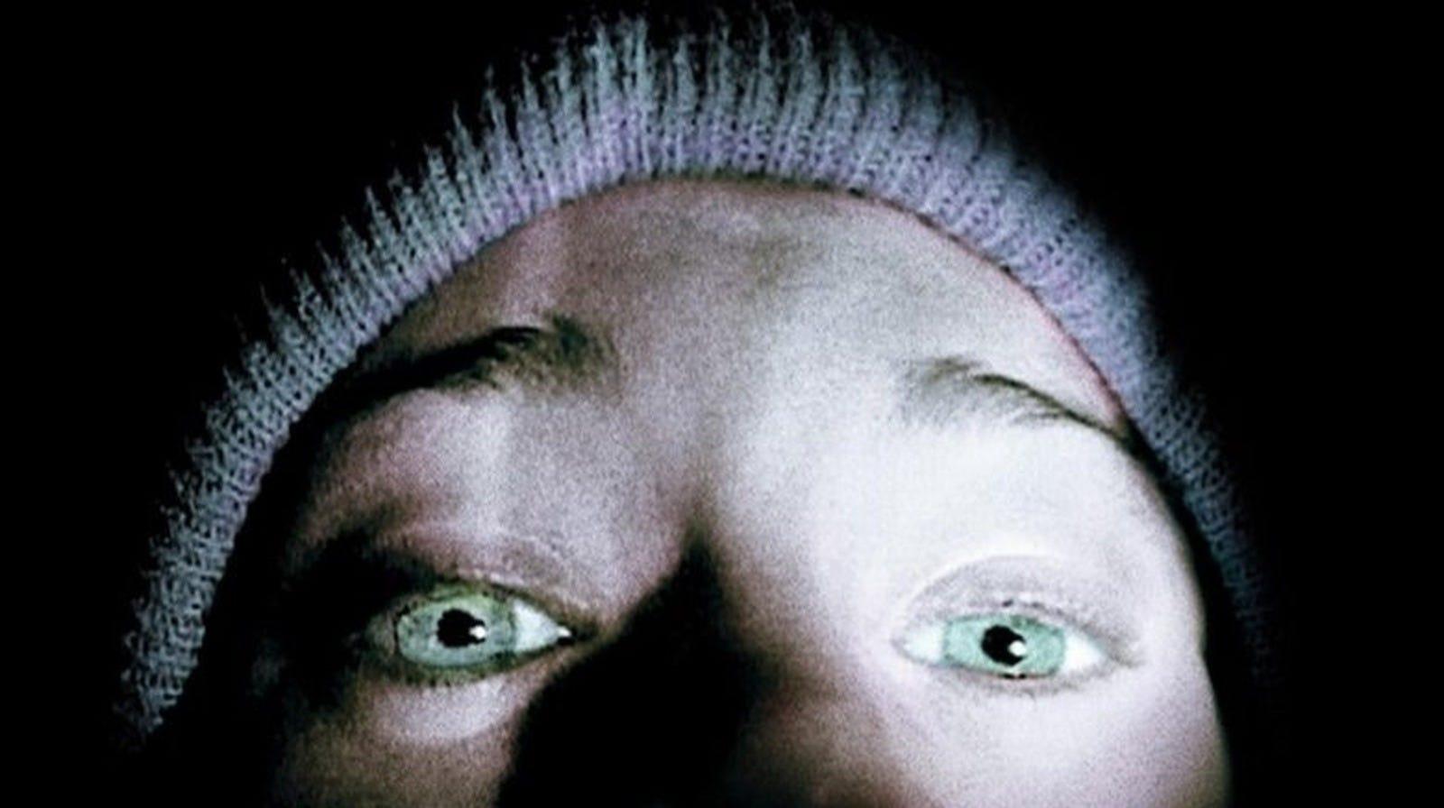 A close-up of a person’s face, focusing on the eyes which are wide open. The person is wearing a knitted hat and the lighting highlights the eyes and forehead while casting shadows over the rest of the face.