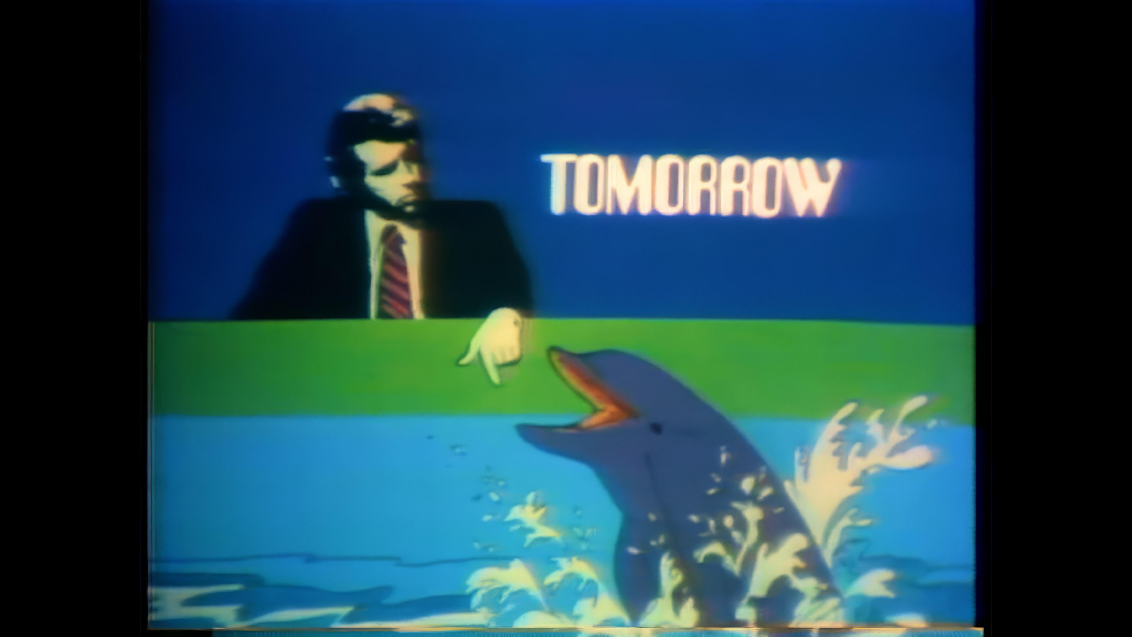 A television animation featuring a man in a suit, a dolphin and the word "TOMORROW".